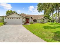 Charming single-story home featuring a well-maintained lawn and an attached two-car garage at 206 Forest Wood Ct, Spring Hill, FL 34609