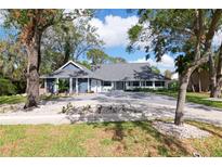 Charming two-story home with mature trees, a long driveway and lovely landscaping at 4202 Deepwater Ln, Tampa, FL 33615