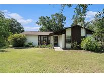 Charming one-story home with a well-maintained lawn and mature trees in a serene setting at 5960 Boyette Rd, Wesley Chapel, FL 33545