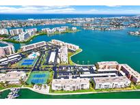 Panoramic aerial view of the waterfront complex featuring tennis courts, pools, and boating access at 7625 Sun Island S Dr # 304, South Pasadena, FL 33707