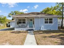 Charming single-story home featuring a welcoming front porch and well-maintained landscaping at 914 E North St, Tampa, FL 33604
