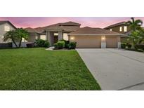 Stunning single-Gathering home featuring a 3-car garage, well-manicured lawn, and lush landscaping at 111 Falling Water Dr, Brandon, FL 33511