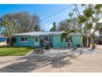 Charming home with a metal roof, delightful landscaping, and a welcoming front entrance at 2010 Bayview Pl, Indian Rocks Beach, FL 33785