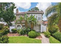 Charming home with beautiful landscaping, tropical plants, and a lovely walkway at 2616 11Th N St, St Petersburg, FL 33704