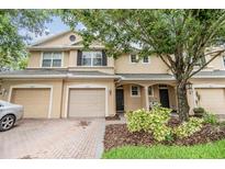 Charming townhome with a well-maintained brick driveway and lush landscaping at 3922 Silverlake Way, Wesley Chapel, FL 33544
