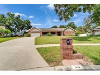 Charming single-story brick home with a well-manicured lawn, mailbox, and attached garage at 414 Summit Chase Dr, Valrico, FL 33594