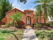 Charming home featuring a barrel tile roof, mature landscaping and inviting arched entryway at 4521 W Azeele St, Tampa, FL 33609