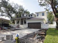 New construction featuring two-story residence with a brick driveway and light exterior paint at 4612 W Tennyson Ave, Tampa, FL 33629