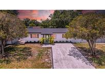 Charming one-story home with updated exterior, lush landscaping, and a newly graveled driveway at 4684 72 N Ave, Pinellas Park, FL 33781