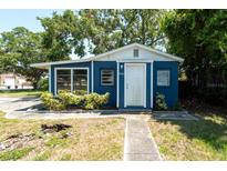 Charming single story home featuring a blue exterior with well-maintained landscaping and mature trees at 5106 15Th S Ave, Gulfport, FL 33707
