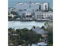 Scenic waterfront view of harbor homes and private boat docks on a sunny day at 8470 W Gulf Blvd # 515, Treasure Island, FL 33706