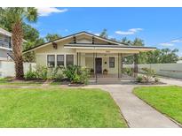 Charming single-story home features a well-manicured lawn and lovely landscaping at 909 E 15Th Ave, Tampa, FL 33605