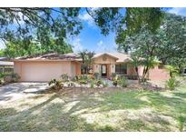 Charming single-story home with a well-manicured lawn and mature landscaping at 107 Halton Cir, Seffner, FL 33584