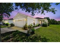 Charming single-story home featuring a well-manicured lawn and attached two-car garage at 12716 Evington Point Dr, Riverview, FL 33579