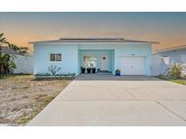 Charming, light blue, single-story home with a well-kept lawn and a welcoming front entrance at 2010 20Th Avenue Pkwy, Indian Rocks Beach, FL 33785