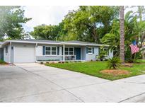 Charming single-story home with a well-maintained lawn, beautiful landscaping, and inviting curb appeal at 415 Mission Hills Ave, Temple Terrace, FL 33617