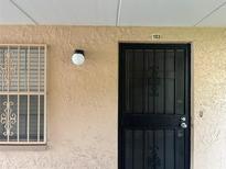 Inviting front entrance featuring a secure door and window with decorative bars at 4708 Michael Ct # 103, Tampa, FL 33614