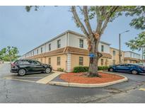 The building boasts tan stucco walls, light-colored siding, and assigned parking spaces for residents and guests at 4708 Michael Ct # 104, Tampa, FL 33614