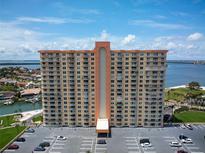 Stunning exterior view of a tall building showcasing the architecture, balconies, and parking area with beautiful landscaping at 4900 Brittany S Dr # 613, St Petersburg, FL 33715