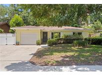 Charming single-story home with a well-maintained front yard, a garage, and a welcoming entrance at 2136 Cunningham Dr, Clearwater, FL 33763