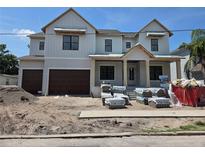 Front exterior of a new two-story home under construction, with a three-car garage at 4208 W Vasconia St, Tampa, FL 33629