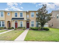 Well-maintained townhome exterior with vibrant landscaping, sidewalk, and manicured lawn at 6920 Towering Spruce Dr, Riverview, FL 33578