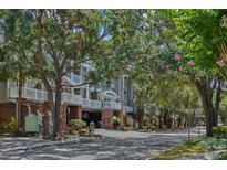 Beautiful condominium complex with mature trees, brick accents, and covered parking at 800 S Dakota Ave # 204, Tampa, FL 33606