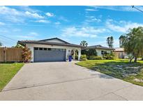 Charming single-story home featuring a two-car garage and well-maintained landscaping at 1399 49Th Ne Ave, St Petersburg, FL 33703