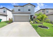 Charming two-story home with a well-manicured lawn and inviting curb appeal and a two car garage at 36312 Garden Wall Way, Zephyrhills, FL 33541