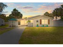 Charming single-story home featuring well-maintained landscaping, a long driveway, and cozy front porch at 512 Flame Tree Dr, Apollo Beach, FL 33572
