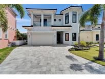 Stunning two-story home featuring a spacious driveway and lush landscaping, creating a grand entrance appeal at 6520 Simone Shores Cir, Apollo Beach, FL 33572
