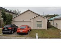 Charming single-story home features a two-car garage and a well-maintained front yard at 11334 Ivy Flower Loop, Riverview, FL 33578