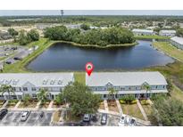 Beautiful waterfront townhomes with lush landscaping and ample parking spaces at 11617 Colony Lake Dr, Tampa, FL 33635