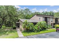 Charming condo with tropical landscaping and a private entrance, offering a welcoming curb appeal at 1400 Tarpon Woods Blvd # E4, Palm Harbor, FL 34685