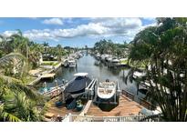 Beautiful waterfront view featuring private docks with boats on a sunny day at 1427 40Th Ne Ave, St Petersburg, FL 33703
