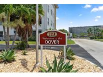 Community sign at The Dover with tropical landscaping and well maintained grounds in a desirable neighborhood at 3114 59Th S St # 203, Gulfport, FL 33707
