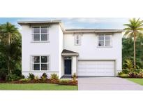 Charming two-story home with a well-maintained lawn and tropical landscaping at 35665 Lockman Way, Zephyrhills, FL 33541