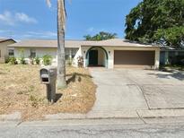 Charming single-story home featuring a well-kept lawn, a two-car garage, and a mailbox in the front yard at 8630 134Th St, Seminole, FL 33776