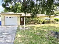 Charming one-story home featuring a well-manicured lawn and a single-car garage at 9797 52Nd N Ter, St Petersburg, FL 33708
