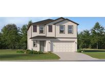 Two-story home featuring manicured lawn, attached two car garage, and beautiful landscaping at 2284 Blue Grosbeak Pl, Wimauma, FL 33598