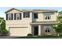 Two-story home with black shutters and a two-car garage, enhanced by lush green landscaping, creates an inviting curb appeal at 35496 Valley Ridge Rd, Dade City, FL 33525