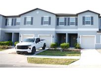 Townhomes feature a neutral palette, shuttered windows and attached garages at 36439 Garden Wall Way, Zephyrhills, FL 33541