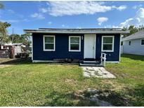 Charming blue home featuring a well-maintained lawn and a welcoming front entrance at 6039 81St N Ave, Pinellas Park, FL 33781