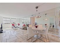 Spacious living room featuring bright natural light and a decorative mirrored wall at 6265 Sun Blvd # 1203, St Petersburg, FL 33715