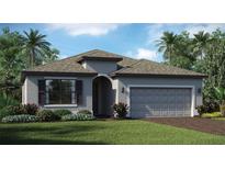 Charming single-story home featuring a well-manicured lawn, gray siding, and a two-car garage, surrounded by lush landscaping and palm trees at 7919 Lakes Edge Ln, Port Charlotte, FL 33981