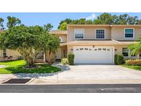 Charming townhouse featuring a two-car garage and well-maintained landscaping at 8980 Antigua Dr, Seminole, FL 33777