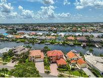 Stunning aerial view of waterfront homes, showcasing boat docks and beautiful waterways in a desirable residential neighborhood at 920 Symphony Isles Blvd, Apollo Beach, FL 33572