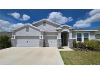 Charming single-story home with a three-car garage and stone accents at 13111 Pepper Stem St, Spring Hill, FL 34609