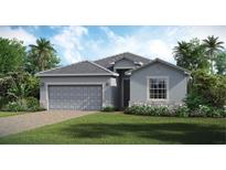 Charming single-story home featuring a two-car garage, neutral tones, and a well-manicured lawn at 15127 Oxford Grey Dr, Bradenton, FL 34211