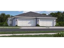 Charming home featuring a spacious two-car garage with white doors and well-maintained landscaping at 15304 Sunny Day Dr, Bradenton, FL 34211